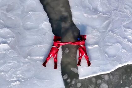 A new extreme winter trend called ice floating is going viral - thrill-seekers in red suits dive into freezing Arctic waters in Russia for the ultimate icy adventure.