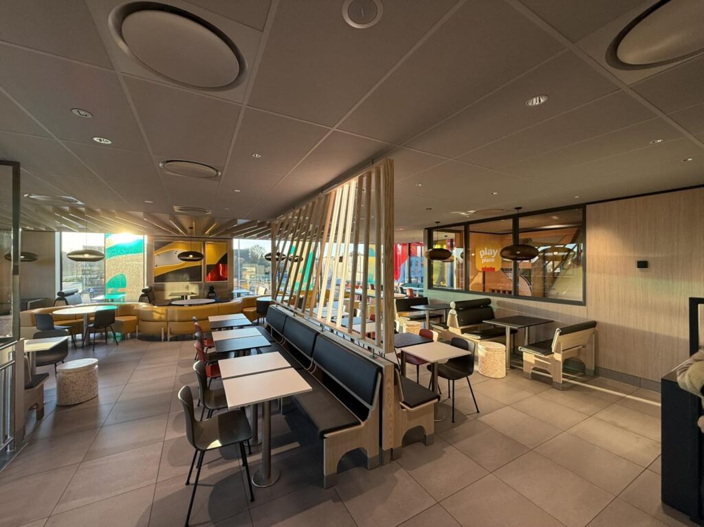 Dutch McDonald’s in Vriezenveen transforms into a giant Christmas present with a glowing bow offering festive giveaways sustainable design features and a celebratory opening for locals.