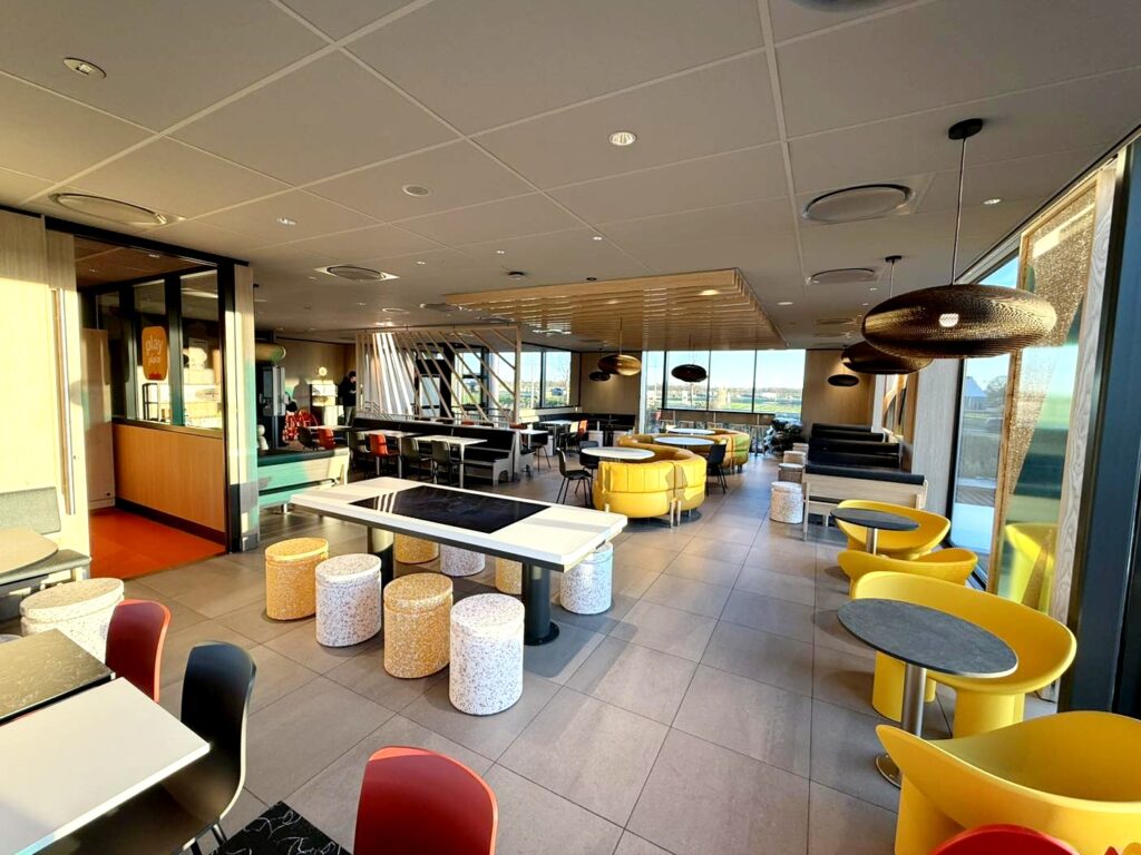 Dutch McDonald’s in Vriezenveen transforms into a giant Christmas present with a glowing bow offering festive giveaways sustainable design features and a celebratory opening for locals.