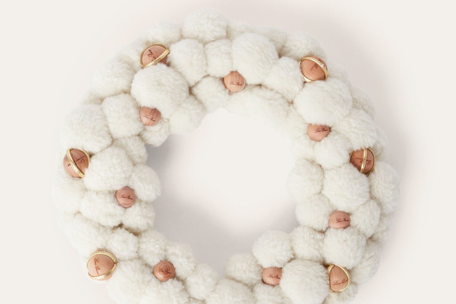 Luxury brand Loro Piana releases 2070 pound cashmere and silk Christmas wreath featuring Cashfur fabric and wooden details sparking buzz as one of the priciest festive decorations ever.