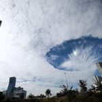 A rare hole punch cloud stunned locals in Puebla City Mexico as a huge fallstreak gap opened in the sky prompting viral photos and alien jokes though experts confirm it is a harmless natural phenomenon.