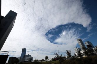 A rare hole punch cloud stunned locals in Puebla City Mexico as a huge fallstreak gap opened in the sky prompting viral photos and alien jokes though experts confirm it is a harmless natural phenomenon.