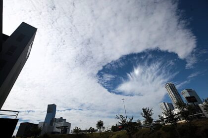 A rare hole punch cloud stunned locals in Puebla City Mexico as a huge fallstreak gap opened in the sky prompting viral photos and alien jokes though experts confirm it is a harmless natural phenomenon.