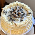 Baker Lauren Klas stuns fans with her ultra-realistic cigarette ashtray cake for a high-low themed party, leaving viewers shocked it’s edible and sparking viral reactions.