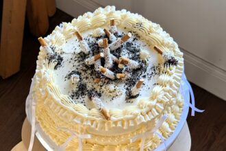 Baker Lauren Klas stuns fans with her ultra-realistic cigarette ashtray cake for a high-low themed party, leaving viewers shocked it’s edible and sparking viral reactions.