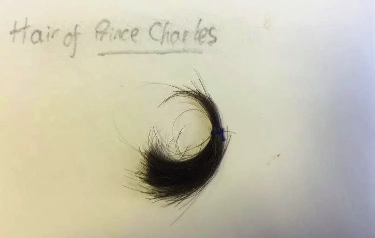 Rare lock of King Charles hair cut in the 1960s by his royal barber goes on sale for 7995 pounds as part of a unique childhood collection featuring tools letters and memorabilia.