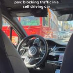 A woman was left mortified when a self-driving Waymo car froze in an intersection blocking a trolley - leaving passengers helpless as honking drivers watched the chaos unfold.