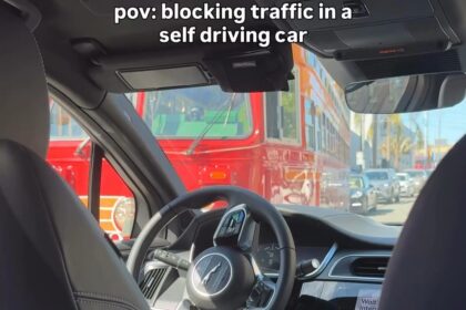 A woman was left mortified when a self-driving Waymo car froze in an intersection blocking a trolley - leaving passengers helpless as honking drivers watched the chaos unfold.