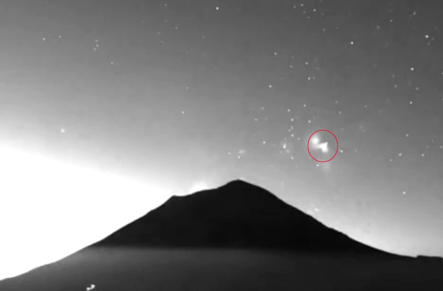 Two triangle shaped UFOs filmed rising from Mexicos Popocatepetl volcano spark wild theories as mysterious glowing objects appear minutes apart above one of the nations most active peaks.