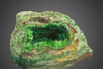 A rare green cuprosklodowskite mineral sample from the Congo is up for auction in Dallas with bids starting at $500 prized for its radioactive beauty and unique uranium rich crystal structure.