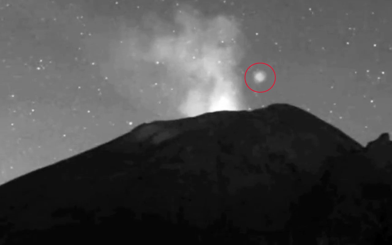 Mysterious glowing UFO caught on camera hovering over Mexico’s Popocatepetl volcano before zipping away. Experts say it could be linked to magnetic field phenomena.