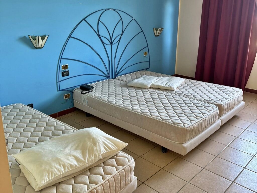 An urban explorer uncovered an abandoned Sicilian hotel with furnished rooms and a decaying swimming pool frozen in time offering a haunting glimpse into its forgotten past.