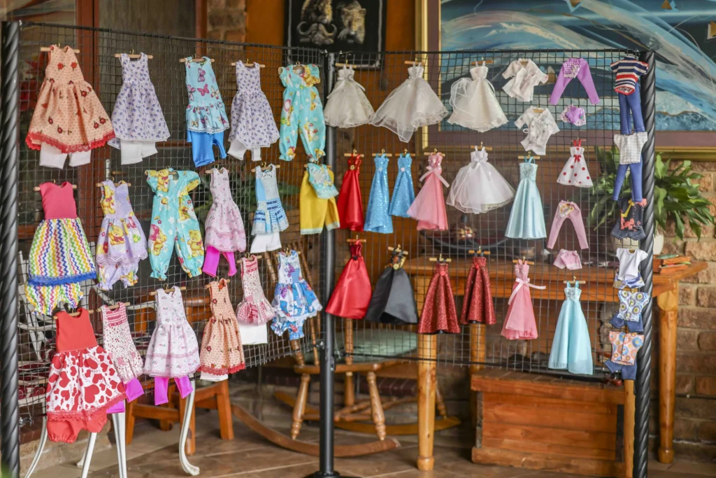 South African woman Marie Odendaal lives with 100 dolls and makes 400 outfits a week treating them as her babies as she talks to them proudly and supports her daughter through her doll clothing business.