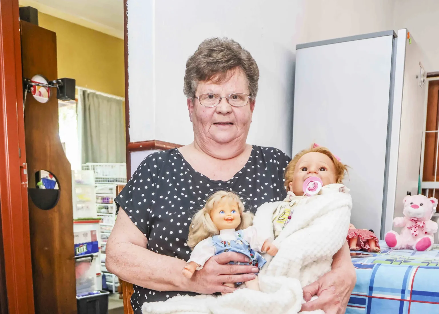 South African woman Marie Odendaal lives with 100 dolls and makes 400 outfits a week treating them as her babies as she talks to them proudly and supports her daughter through her doll clothing business.