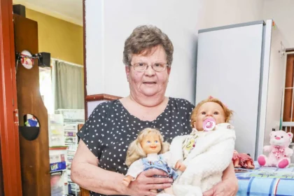 South African woman Marie Odendaal lives with 100 dolls and makes 400 outfits a week treating them as her babies as she talks to them proudly and supports her daughter through her doll clothing business.