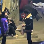 A beluga whale soaks a man smoking in a no smoking zone in a viral staged clip filmed for a fire safety campaign as clever beluga Pomegranate delights viewers with perfect timing.