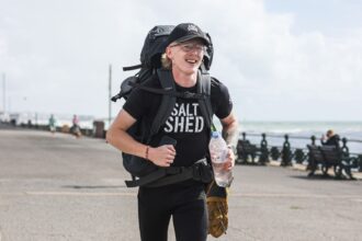 Teen runner Kyle Matthews tackles a marathon a day to run the UK perimeter battling loneliness injury and mental strain while raising money and pushing his resilience to the limit.