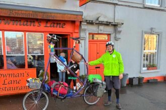 Cyclist turns heads riding six foot tall handmade bike across Ireland as French adventurer pedals unique creation built from recycled parts on language learning tour.