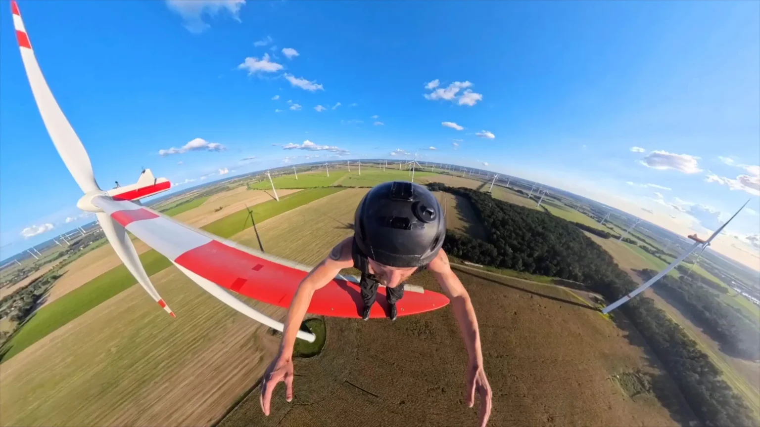 Daredevil George King leaps from spinning wind turbine blades hundreds of feet in the air as the notorious Shard climber pulls off one of his most extreme stunts yet.