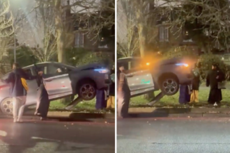 Baffled locals watch as a silver hatchback ends up balanced on a bent bollard in north London leaving wheels off the ground and jokes flying near Spurs stadium at rush hour.