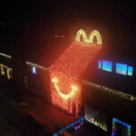 Dutch home transforms into a giant McDonalds Happy Meal box for Christmas on the Netherlands most beautiful festive street, as neighbours create a dazzling holiday village.