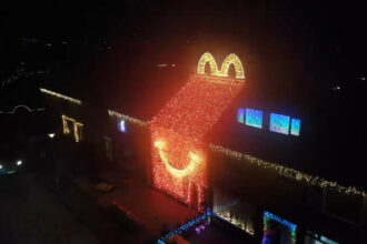 Dutch home transforms into a giant McDonalds Happy Meal box for Christmas on the Netherlands most beautiful festive street, as neighbours create a dazzling holiday village.