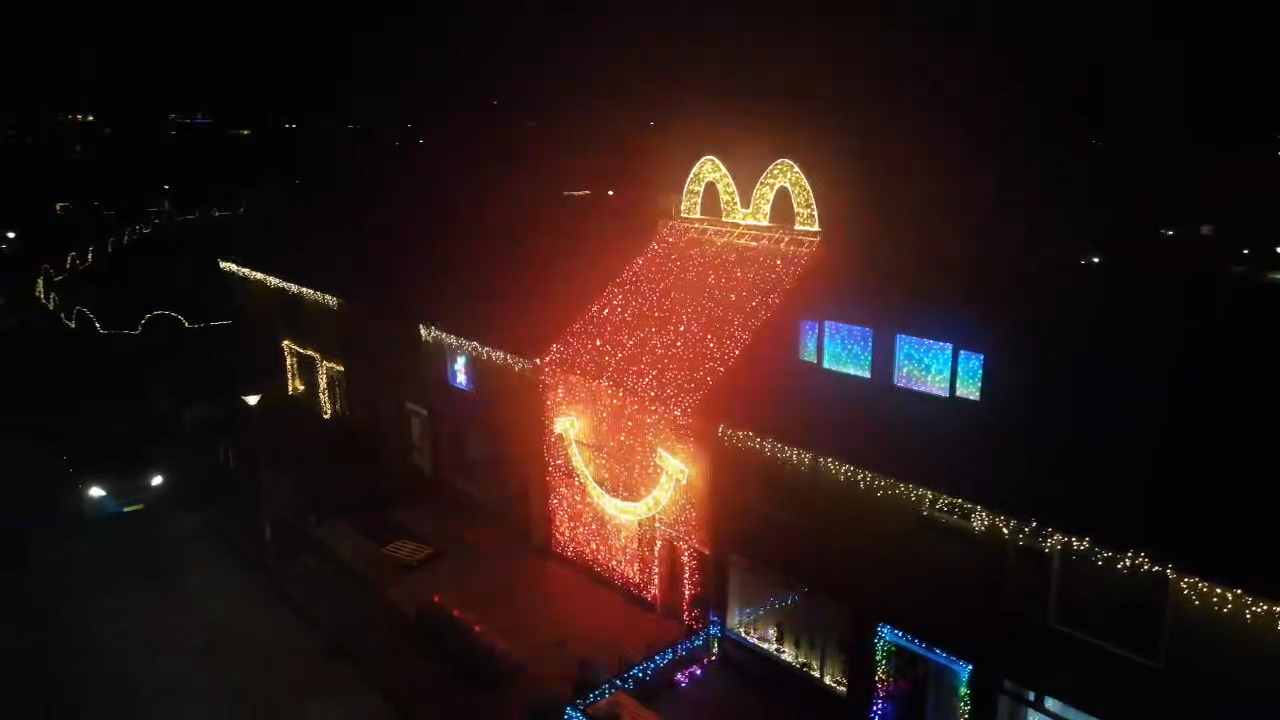Dutch home transforms into a giant McDonalds Happy Meal box for Christmas on the Netherlands most beautiful festive street, as neighbours create a dazzling holiday village.