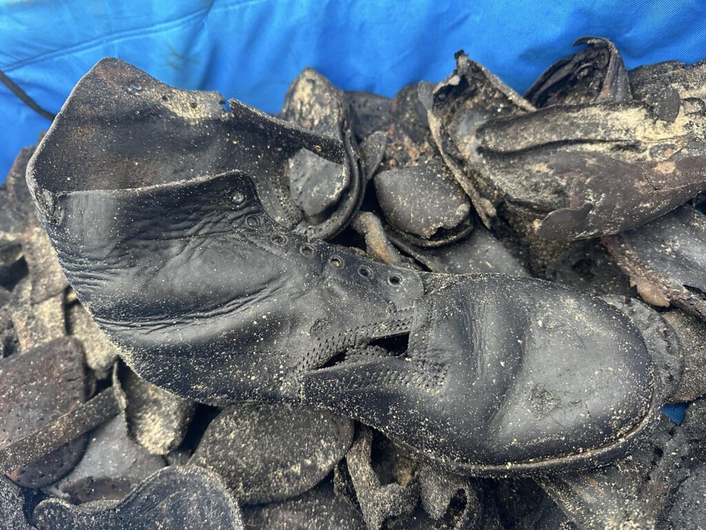 Hundreds of handmade leather shoes from a 150 year old shipwreck wash up on Welsh beach, baffling volunteers as rare footwear emerges from rock pools after erosion.