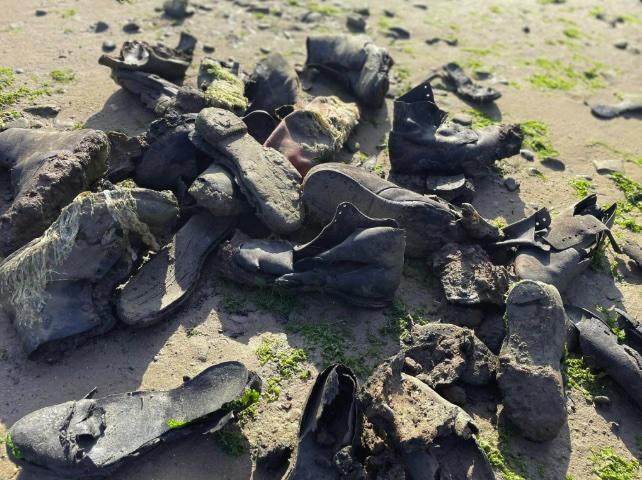 Hundreds of handmade leather shoes from a 150 year old shipwreck wash up on Welsh beach, baffling volunteers as rare footwear emerges from rock pools after erosion.