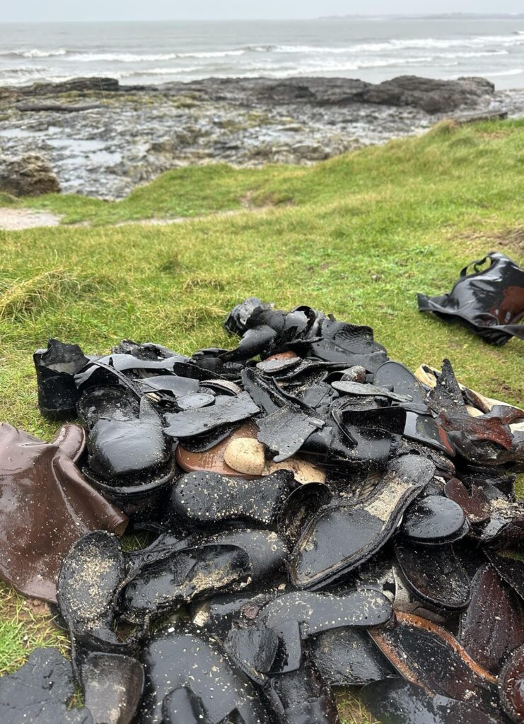 Hundreds of handmade leather shoes from a 150 year old shipwreck wash up on Welsh beach, baffling volunteers as rare footwear emerges from rock pools after erosion.