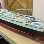Retired craftsman builds stunning 13ft QE2 model over five months using original blueprints, complete with passengers, pool and lights, now on display in Kent.