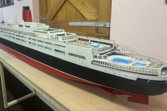 Retired craftsman builds stunning 13ft QE2 model over five months using original blueprints, complete with passengers, pool and lights, now on display in Kent.