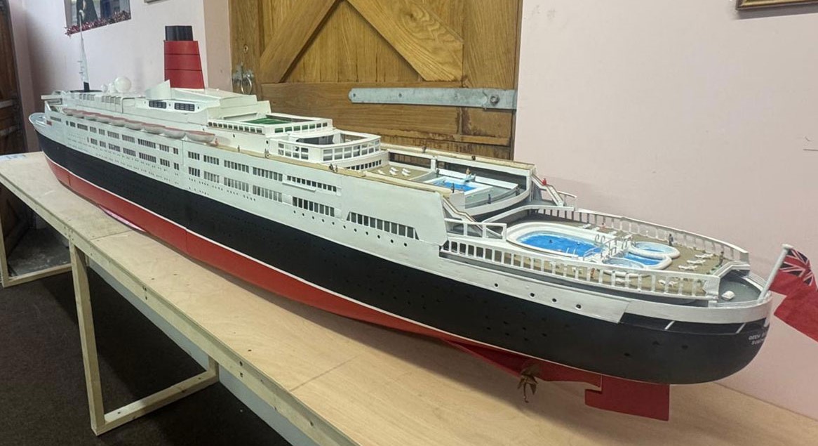 Retired craftsman builds stunning 13ft QE2 model over five months using original blueprints, complete with passengers, pool and lights, now on display in Kent.