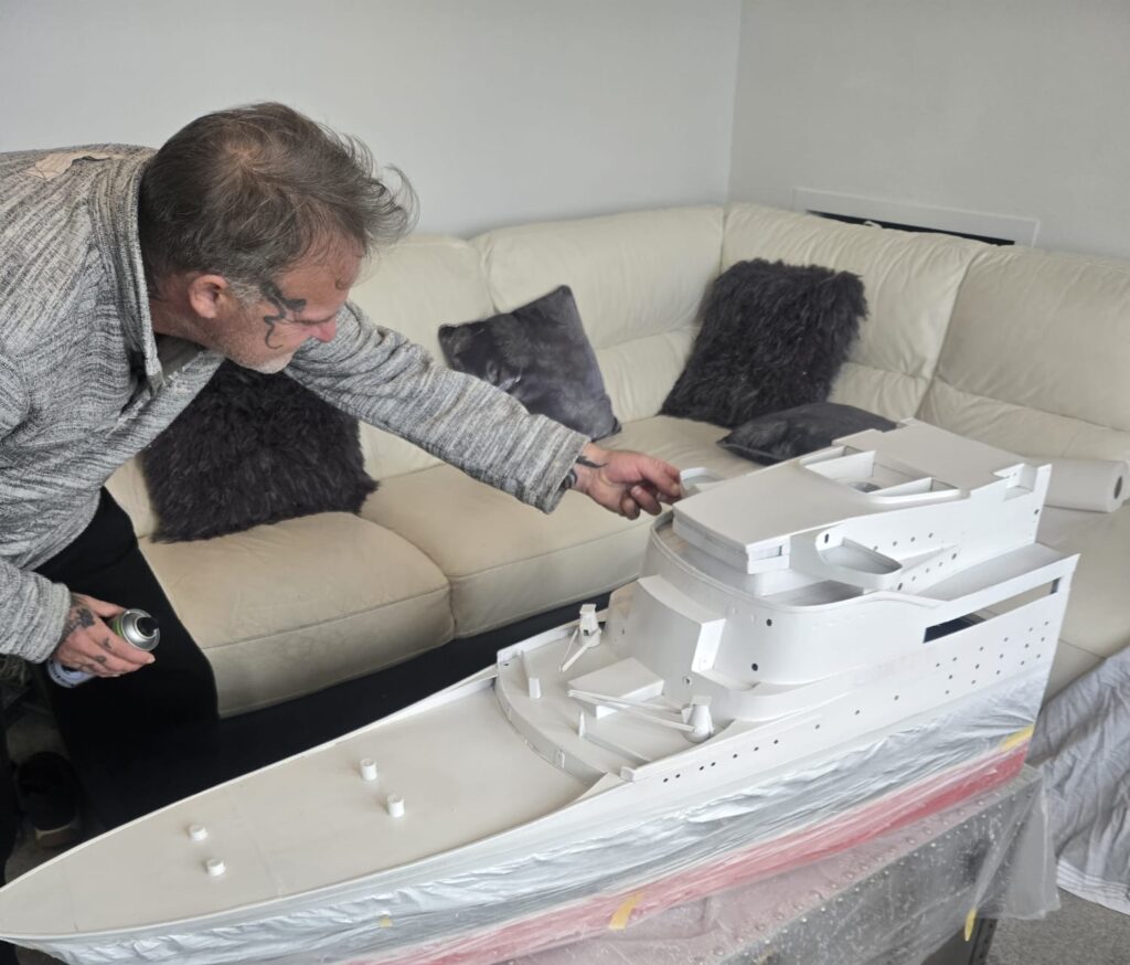 Retired craftsman builds stunning 13ft QE2 model over five months using original blueprints, complete with passengers, pool and lights, now on display in Kent.