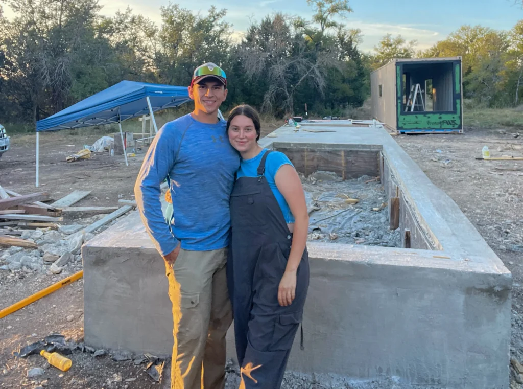 Influencer reveals stunning shipping container home with spiral staircase rooftop deck and sunrise views as couple turn $180k build into cosy sustainable dream Airbnb.