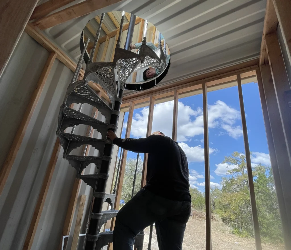 Influencer reveals stunning shipping container home with spiral staircase rooftop deck and sunrise views as couple turn $180k build into cosy sustainable dream Airbnb.