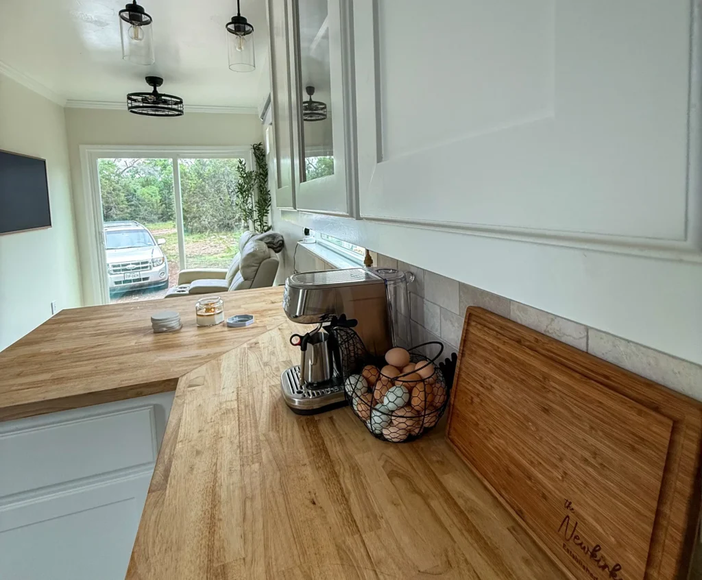 Influencer reveals stunning shipping container home with spiral staircase rooftop deck and sunrise views as couple turn $180k build into cosy sustainable dream Airbnb.