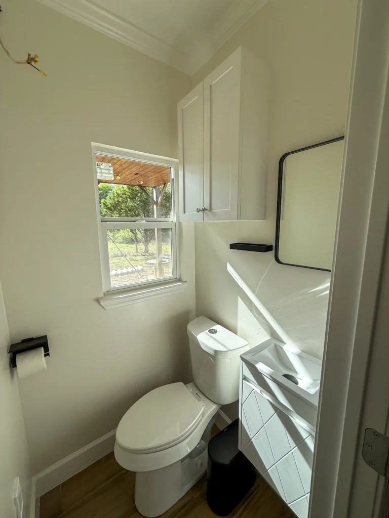 Influencer reveals stunning shipping container home with spiral staircase rooftop deck and sunrise views as couple turn $180k build into cosy sustainable dream Airbnb.