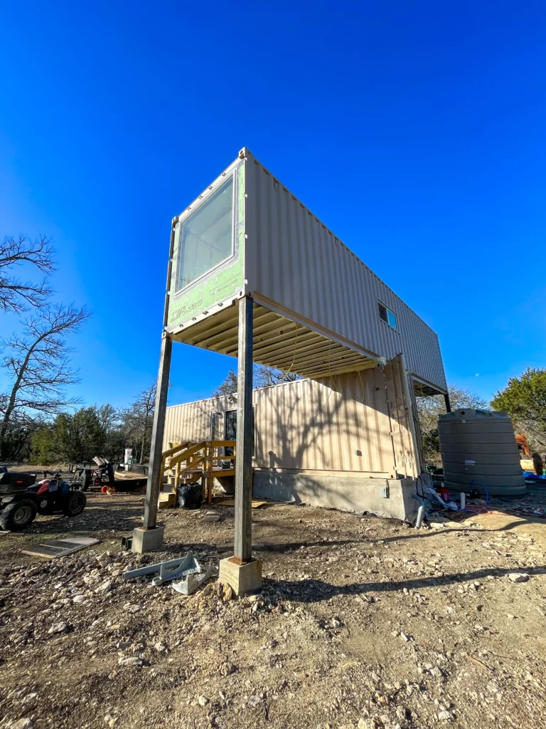 Influencer reveals stunning shipping container home with spiral staircase rooftop deck and sunrise views as couple turn $180k build into cosy sustainable dream Airbnb.