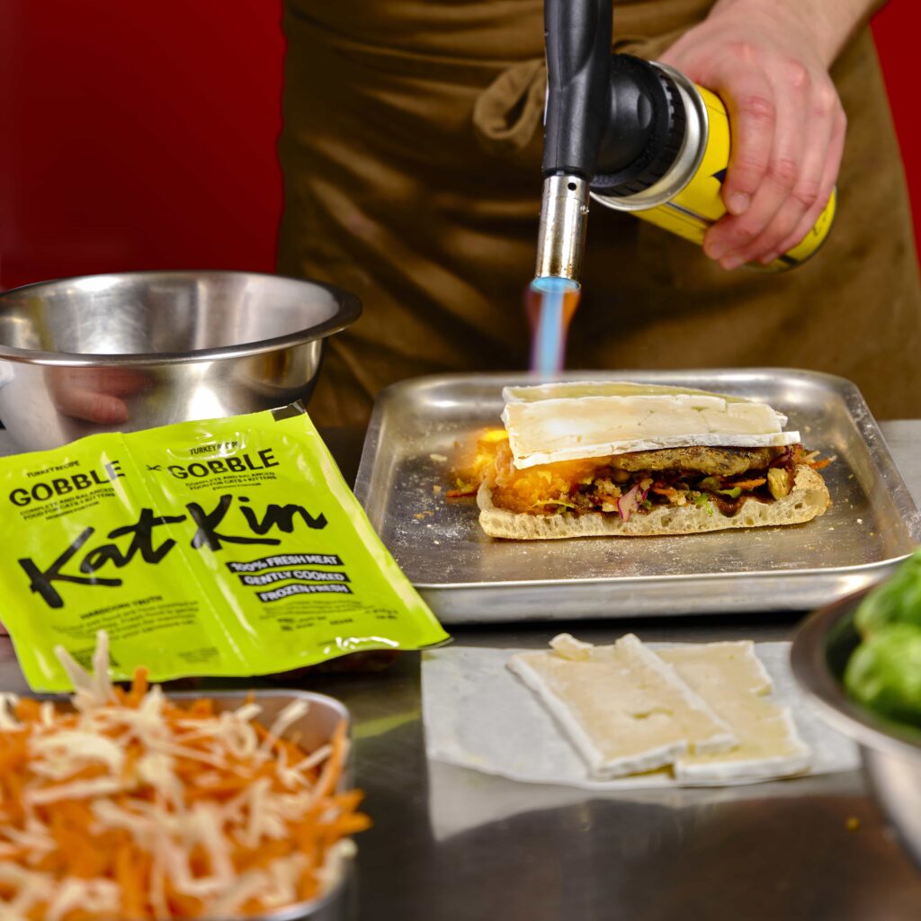 A Michelin trained chef unveils a strange festive cat food Christmas sandwich using “human quality” turkey from KatKin but its overpowering smell makes it nearly impossible to eat.