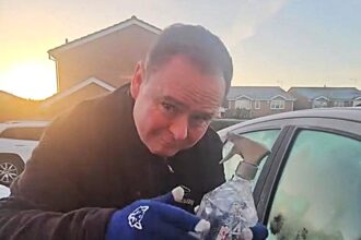 Driver shares free de icing hack using warm water in an old spray bottle to clear frozen windscreens in seconds saving money and time on cold winter mornings across the UK.