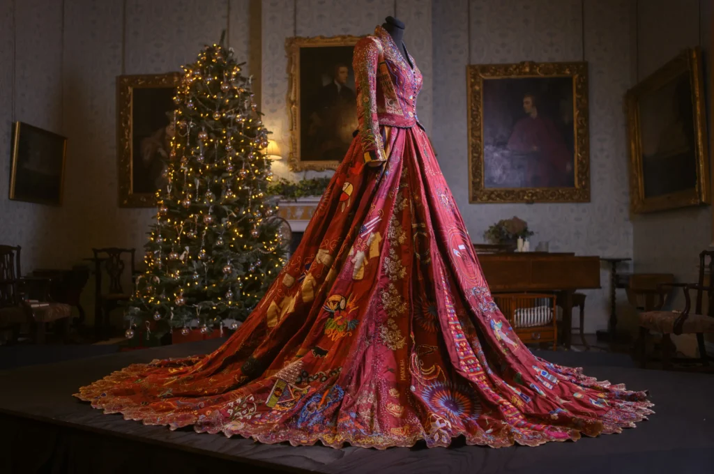 A world record-breaking dress created by 380 people across 51 countries over 14 years has gone on display, featuring 1.5 billion stitches and weighing 15lb with elaborate embroidered panels.