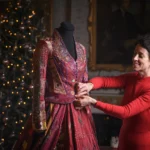 A world record-breaking dress created by 380 people across 51 countries over 14 years has gone on display, featuring 1.5 billion stitches and weighing 15lb with elaborate embroidered panels.