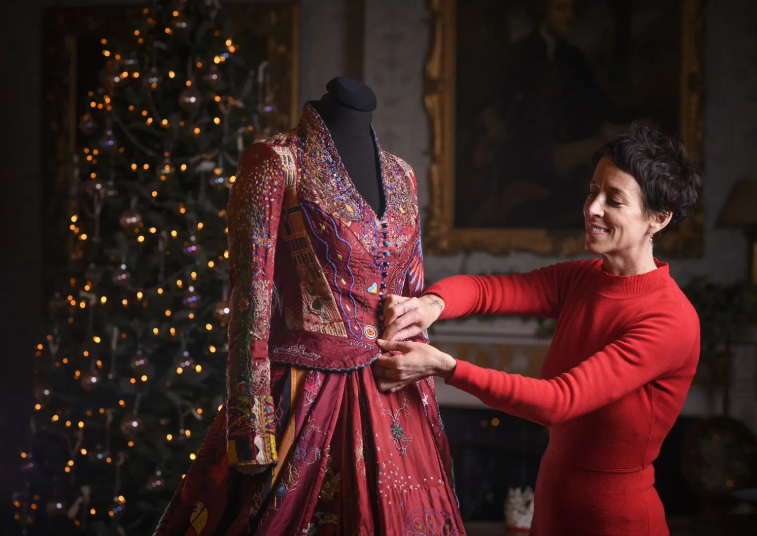 A world record-breaking dress created by 380 people across 51 countries over 14 years has gone on display, featuring 1.5 billion stitches and weighing 15lb with elaborate embroidered panels.