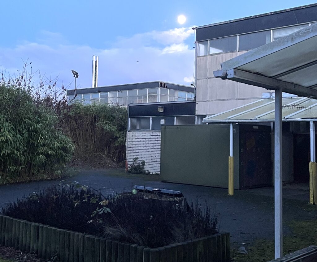 Urban explorer uncovers eerie abandoned primary school frozen in time since 2012, with ivy filled classrooms mouldy halls and grass growing indoors near Kent in darkness.