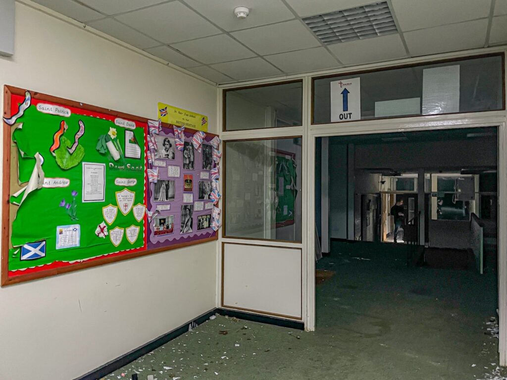 Urban explorer uncovers eerie abandoned primary school frozen in time since 2012, with ivy filled classrooms mouldy halls and grass growing indoors near Kent in darkness.