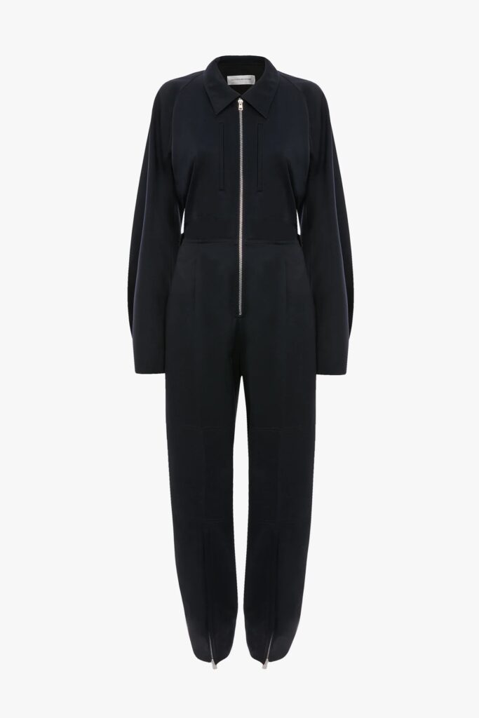 Victoria Beckham’s new £1,190 cargo jumpsuit sparks chatter for its mechanic style look as the designer reimagines workwear with wool blend fabric silver zips and utilitarian details.