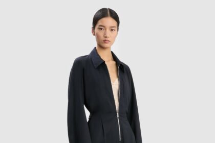 Victoria Beckham’s new £1,190 cargo jumpsuit sparks chatter for its mechanic style look as the designer reimagines workwear with wool blend fabric silver zips and utilitarian details.