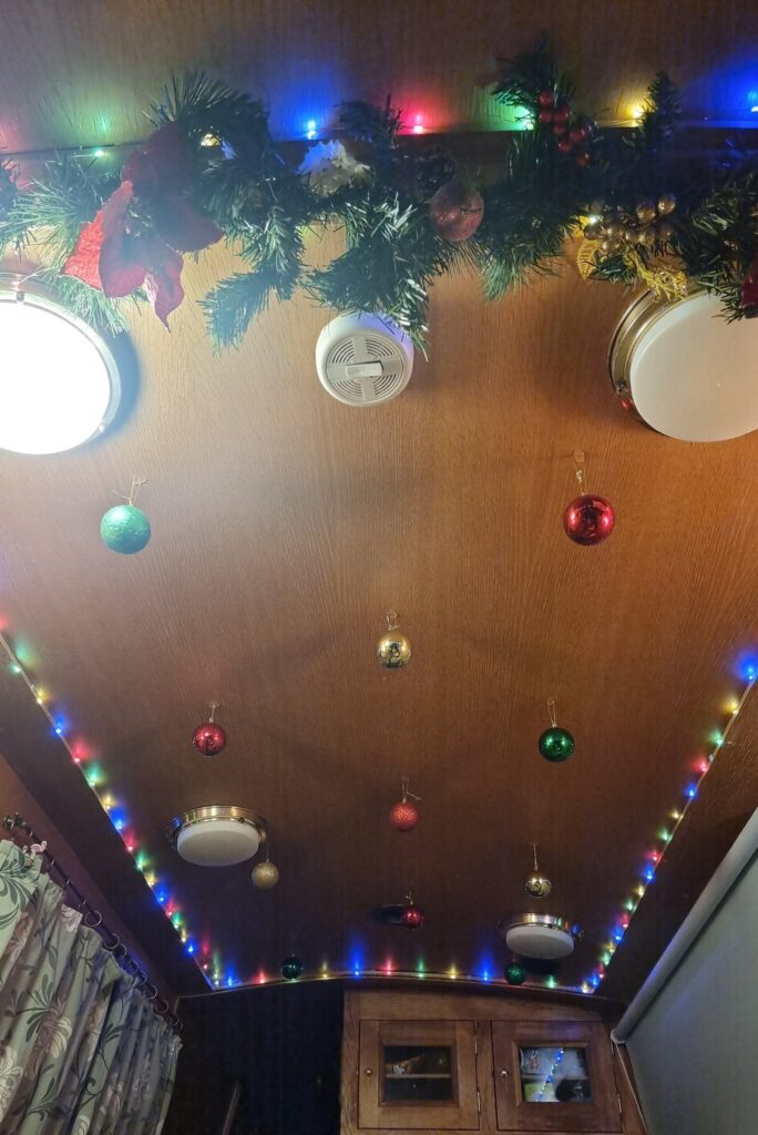 Couple living on a 57ft narrowboat reveal the joys and challenges of moving every two weeks saving money while embracing a cosy peaceful lifestyle that feels like a nonstop holiday even at Christmas.