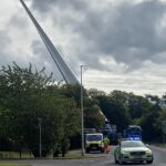 A towering 100 foot wind turbine blade amazes locals as it travels upright on a lorry through the Scottish Highlands showcasing the scale and spectacle of modern green energy projects.